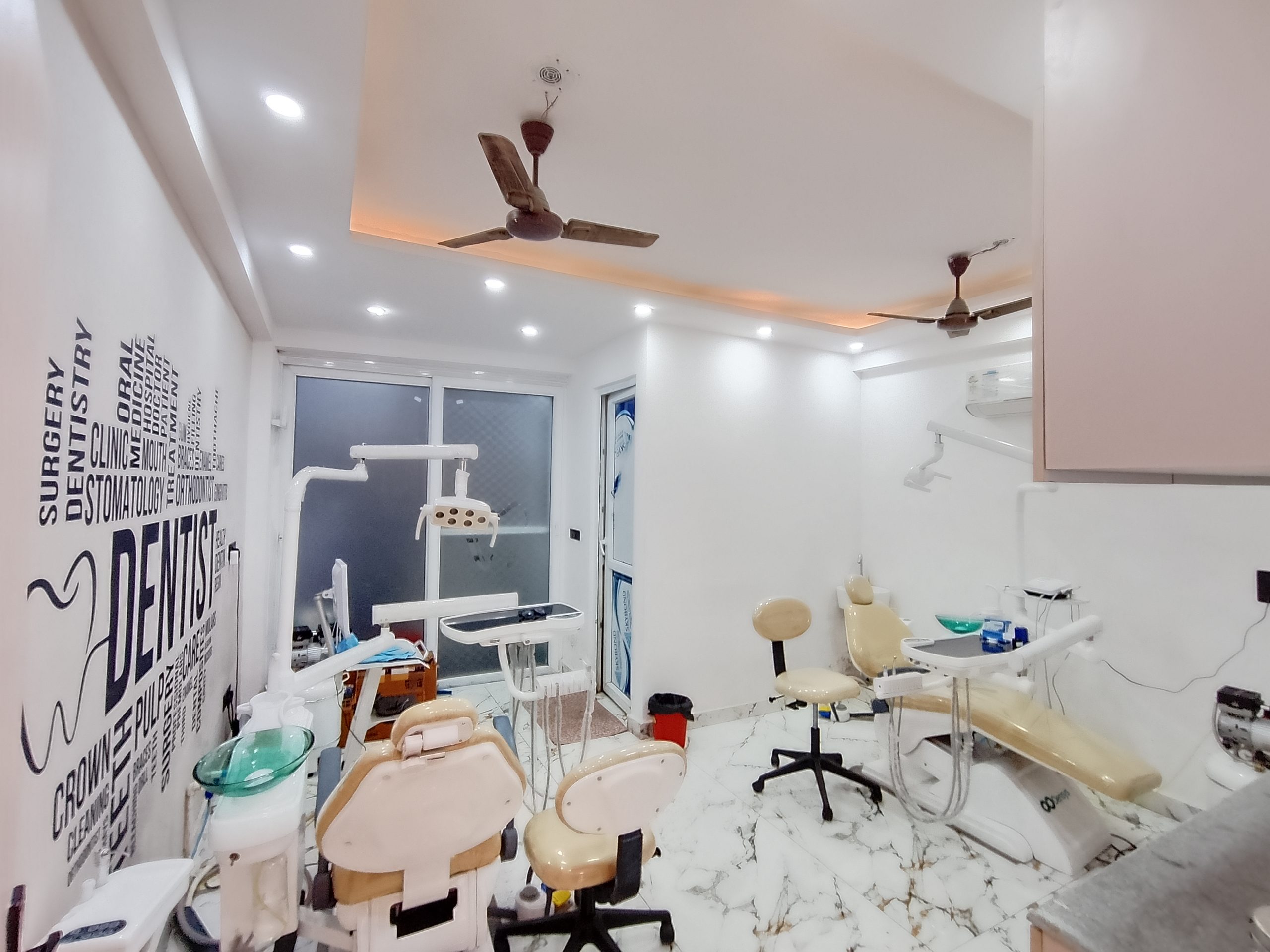 Professional dentist providing advanced dental treatment to a smiling patient at Dentare Clinic in Jamia Nagar.